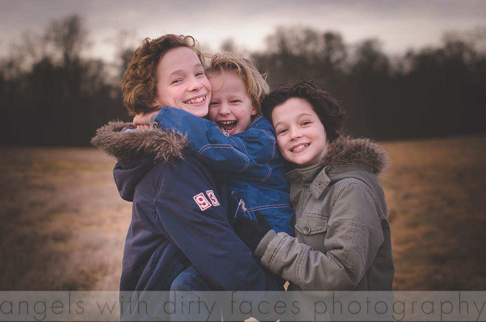 Siblings smile natural as they enjoy a joke in hertfordshire