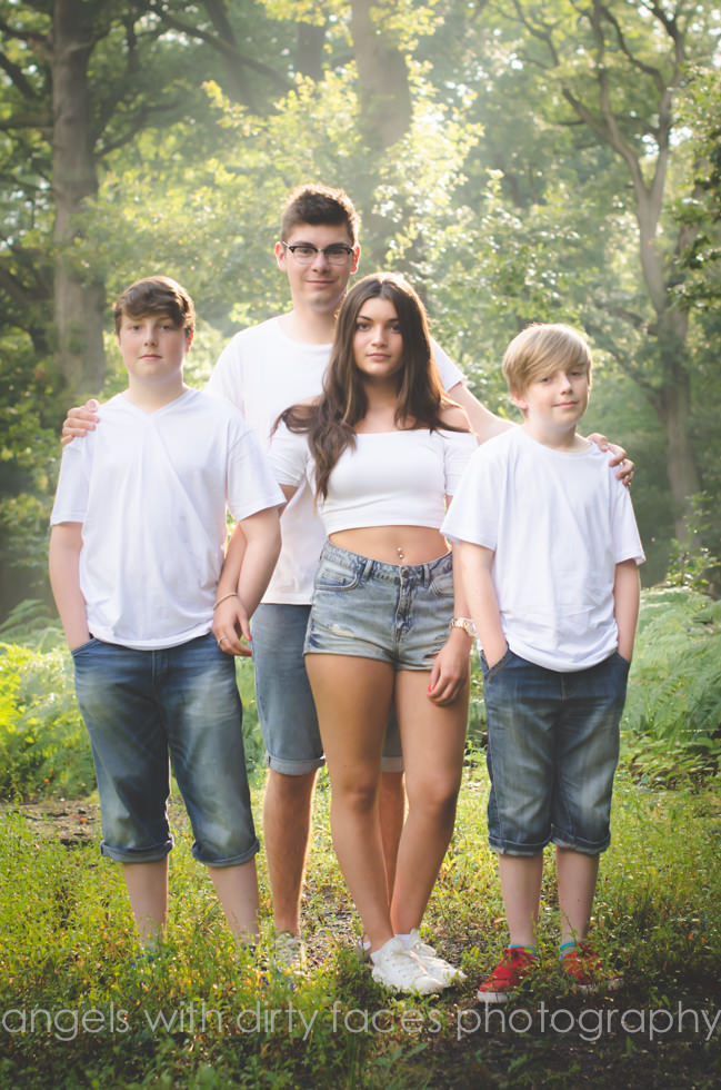 family photographer in welwyn garden city captures cousins in misty woodland setting