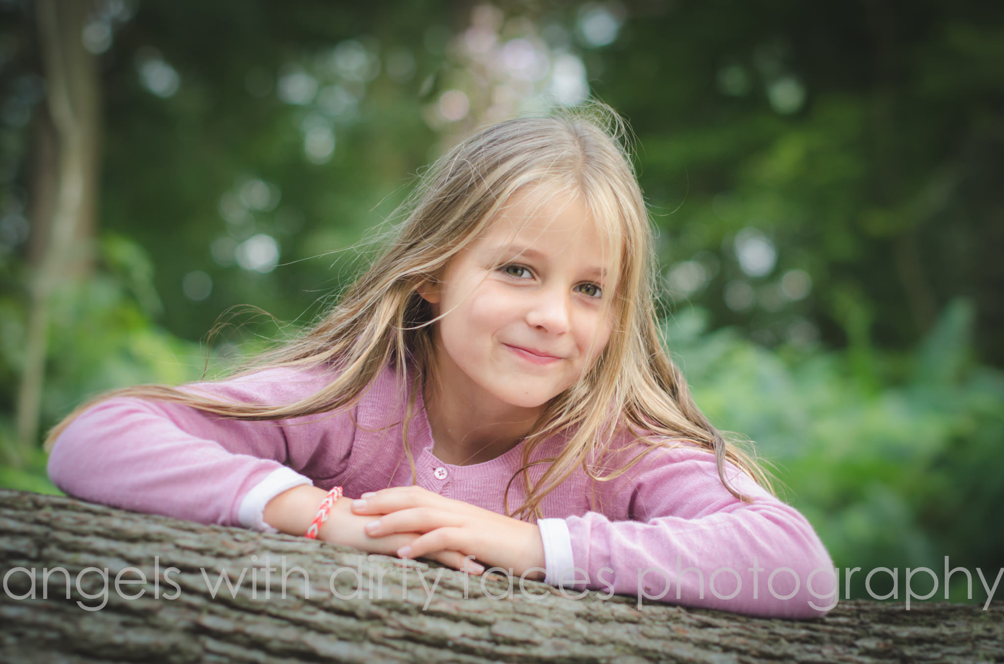 woodland family photo shoot captures a young girl smiling in the woods