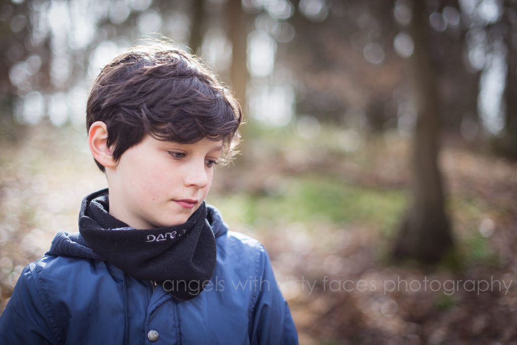 thoughtful looking portrait of boy taken by Family Lifestyle Photographer in Hertfordshire