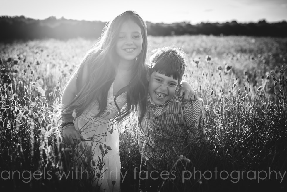 natural child photography in hertfordshire with two young siblings hugging