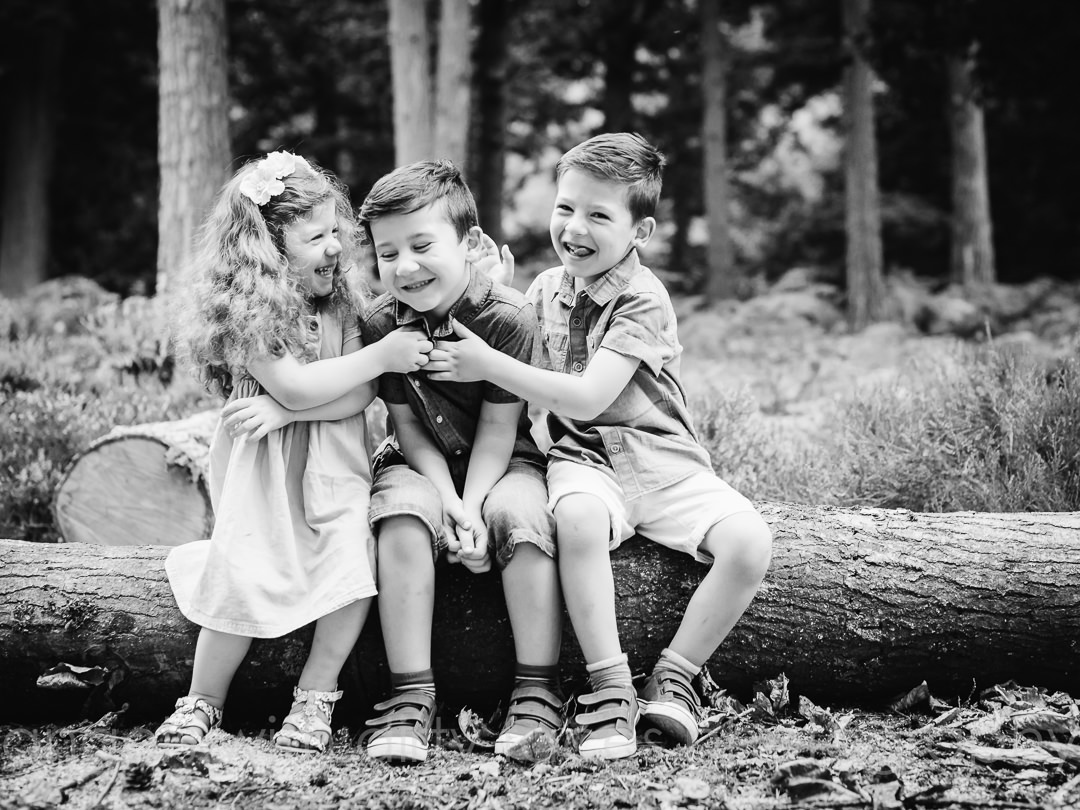 siblings tickle each other in welwyn garden city woods