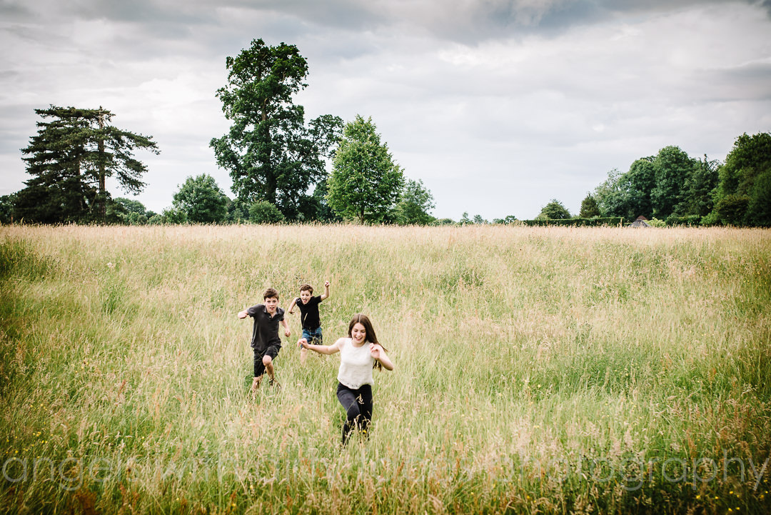 children run through the countryside at their hertfordshire photo shoot