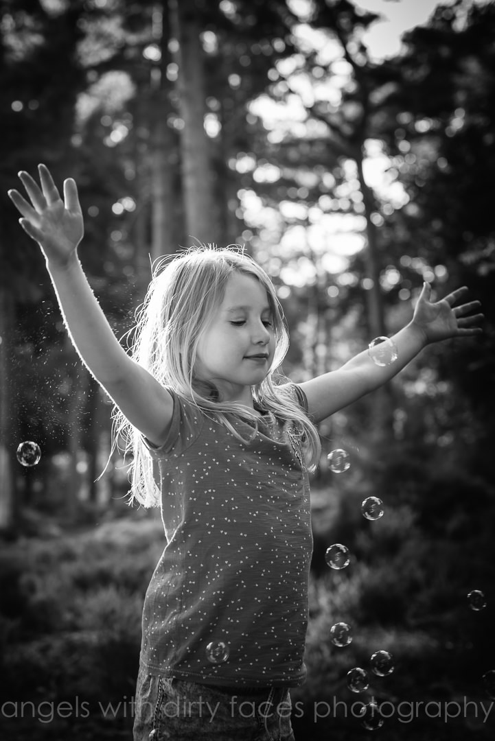 young girl plays with bubbles in Hertfordshire photo shoot