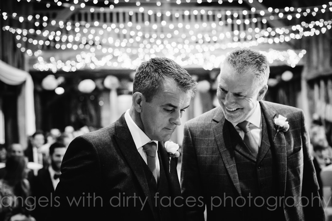 groom and best man wait at the alter at Tewin Bury Farm wedding