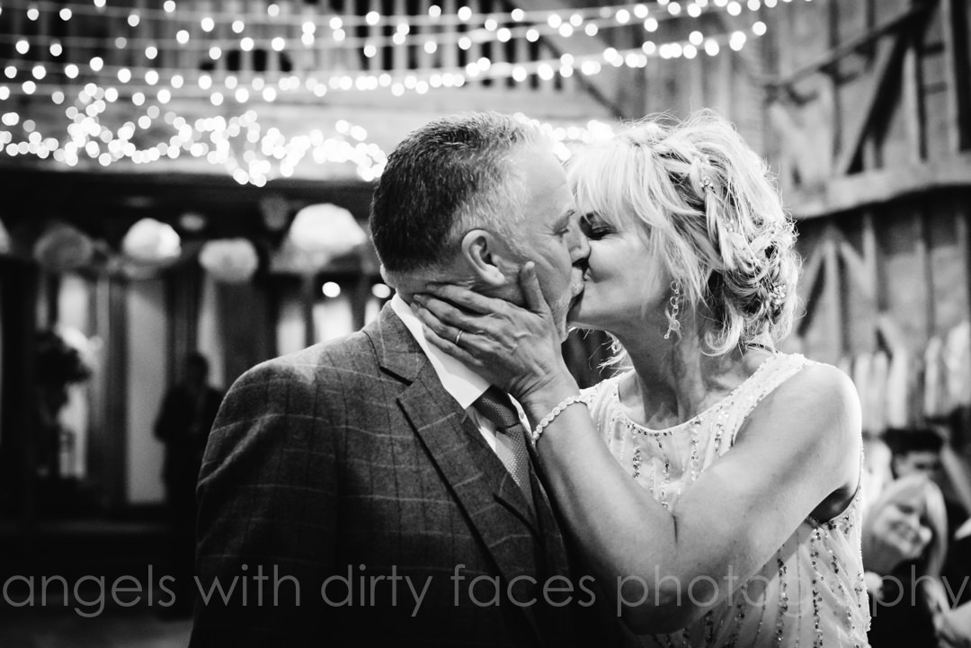 bride and groom have their first kiss after their tewin bury farm wedding ceremony
