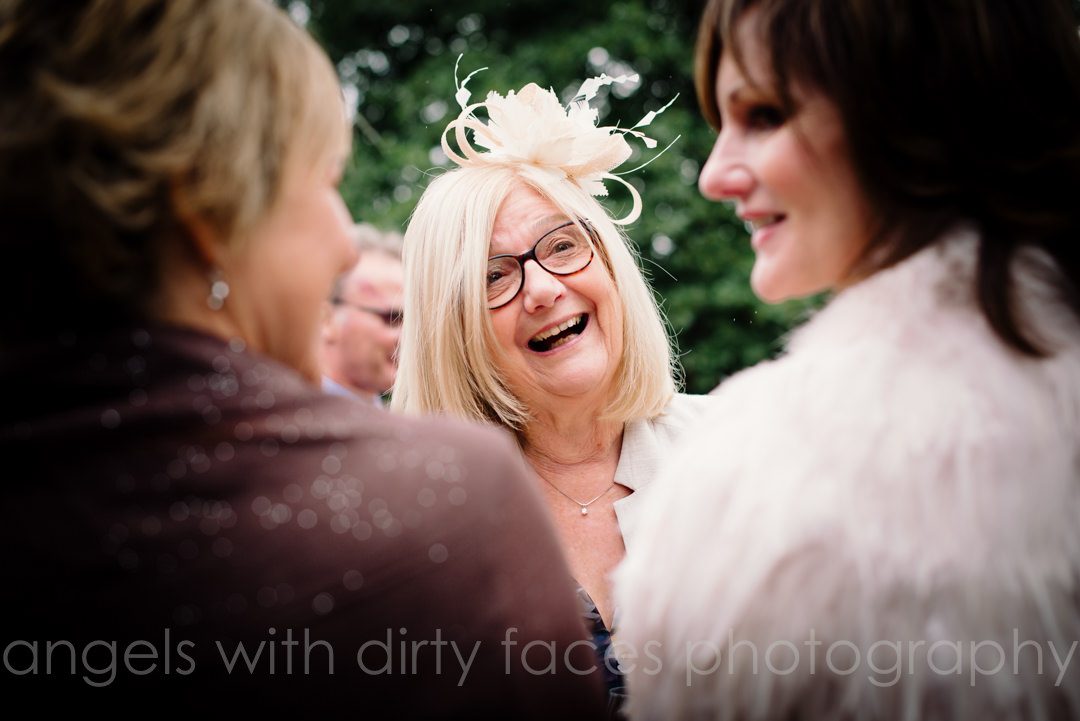 wedding guests chat happily at tewin bury farm wedding 