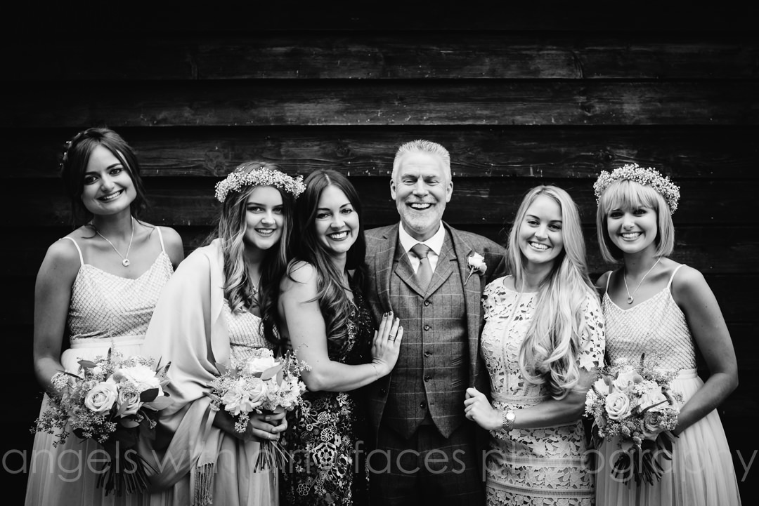 groom and the bridesmaids stand together at tewin bury farm