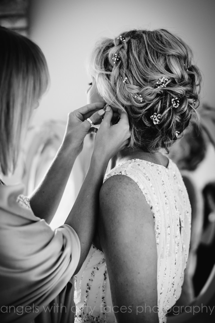 Earrings are put on before the Hertfordshire wedding