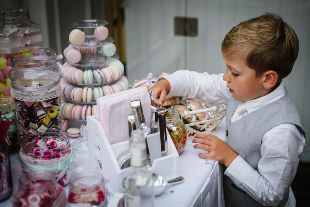 little boy tucking into the sweet table at a hertfordshire wedding