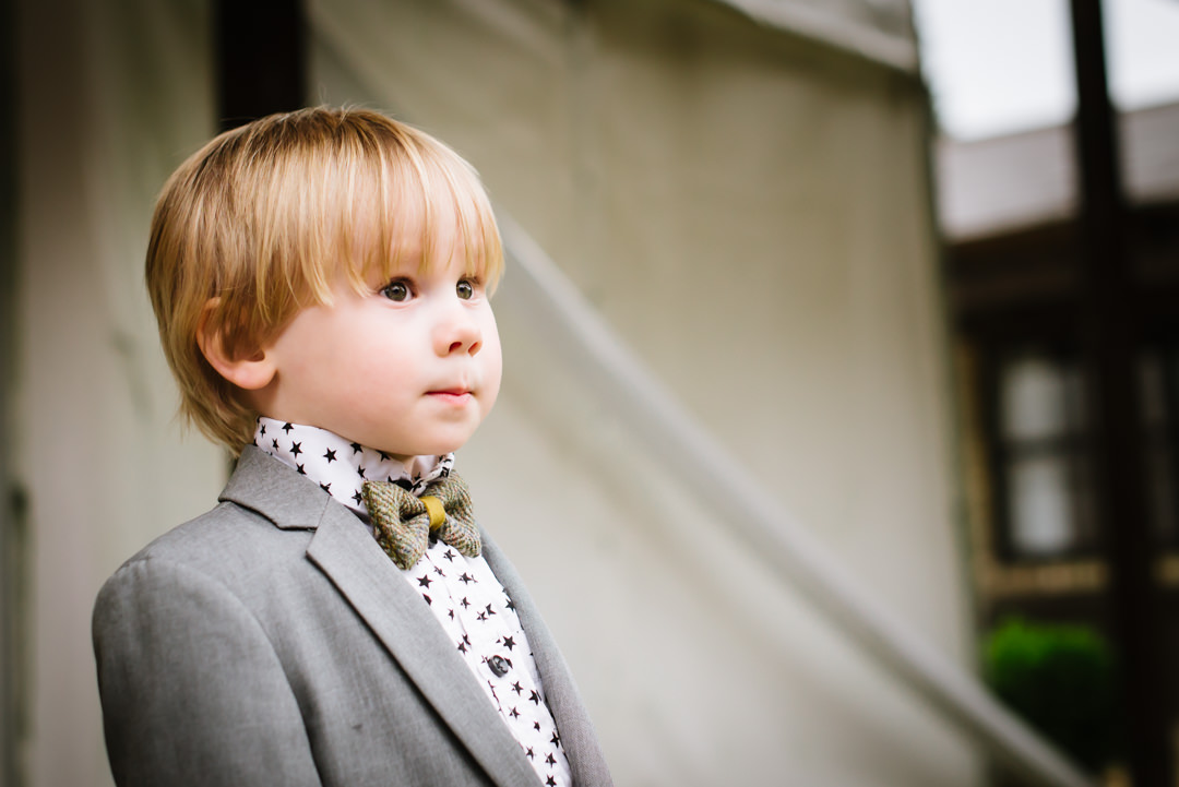 Smart little child wears his bow tie with pride iat Hertfordshire wedding
