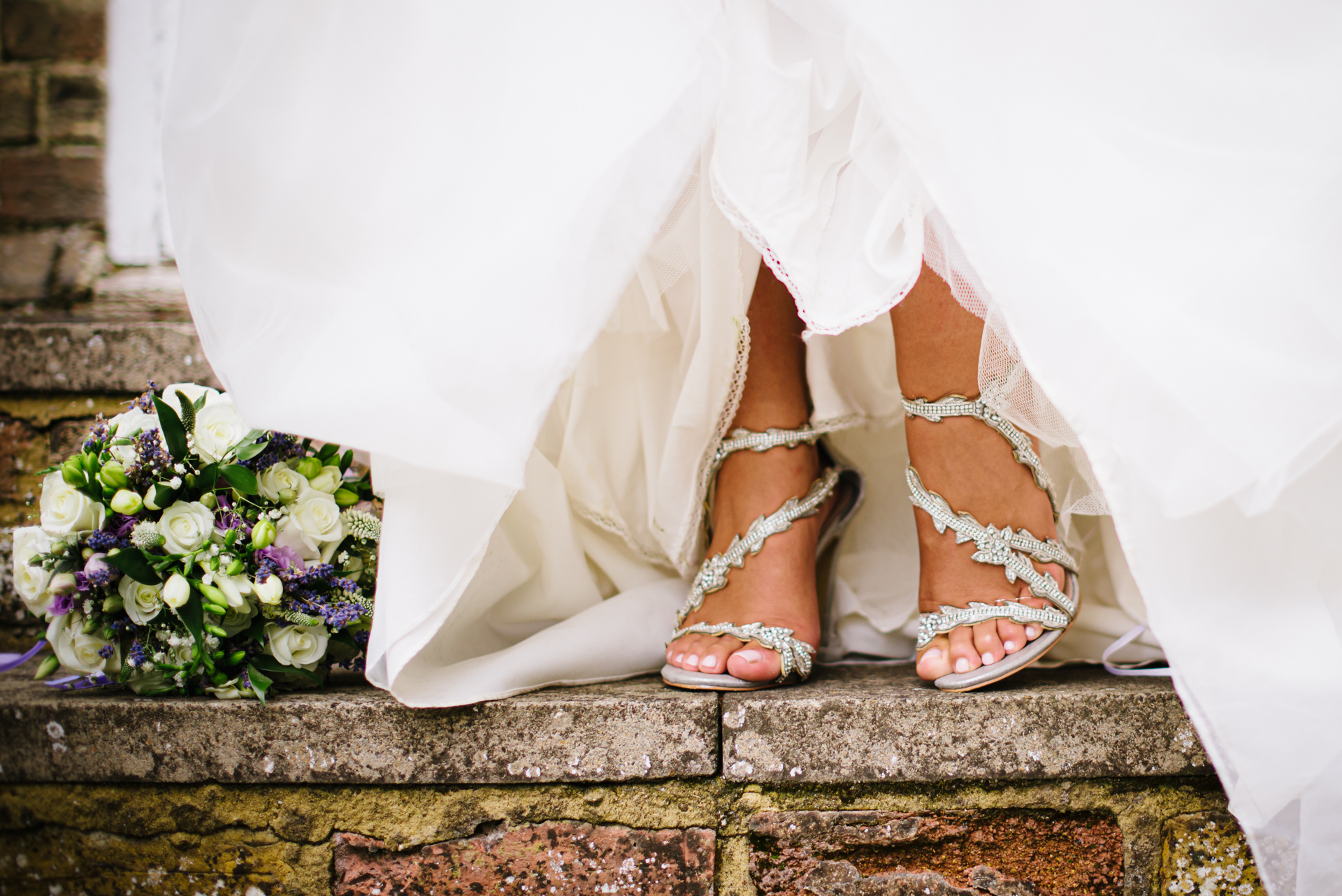 Brides shoes and bouquet