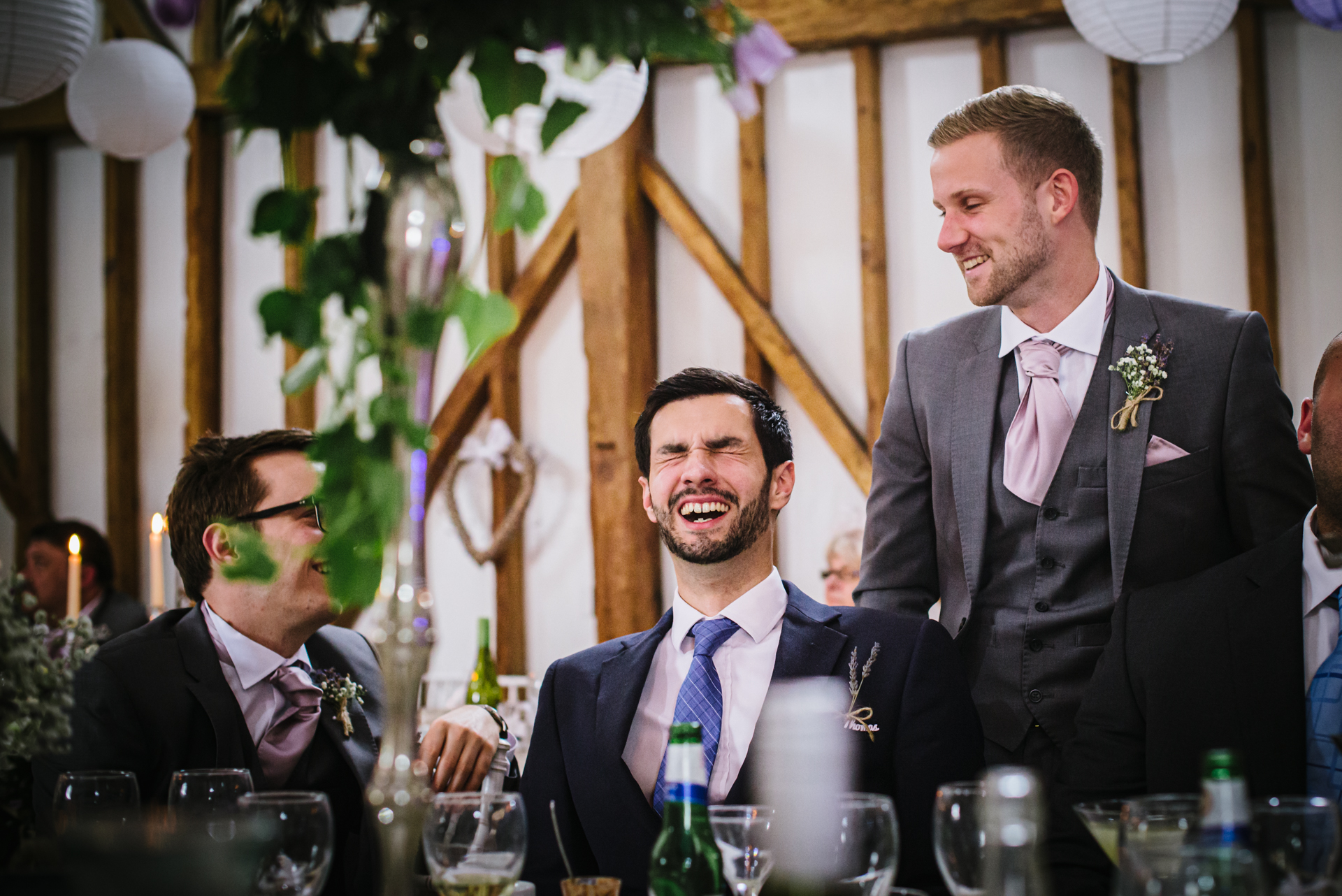 Best men share a joke at Milling Barn wedding reception