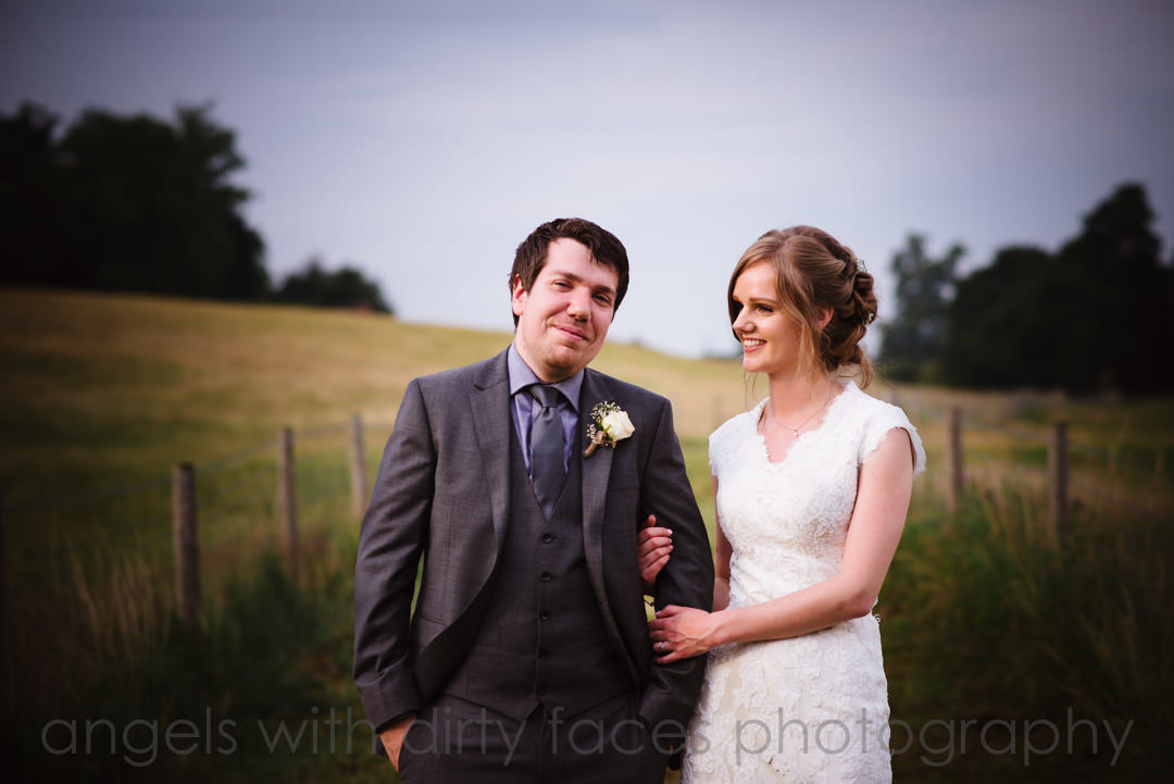 Bride and groom walk along the countryside at tewin bury farm hotel