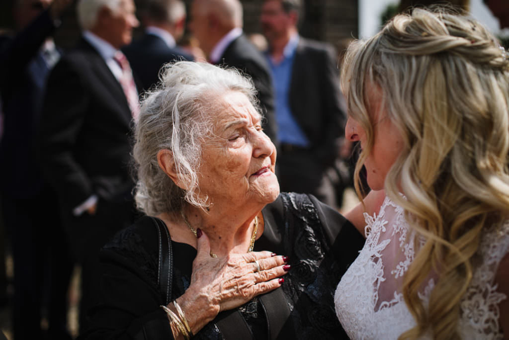 grandmother looking proudly at bride at rowley barn wedding