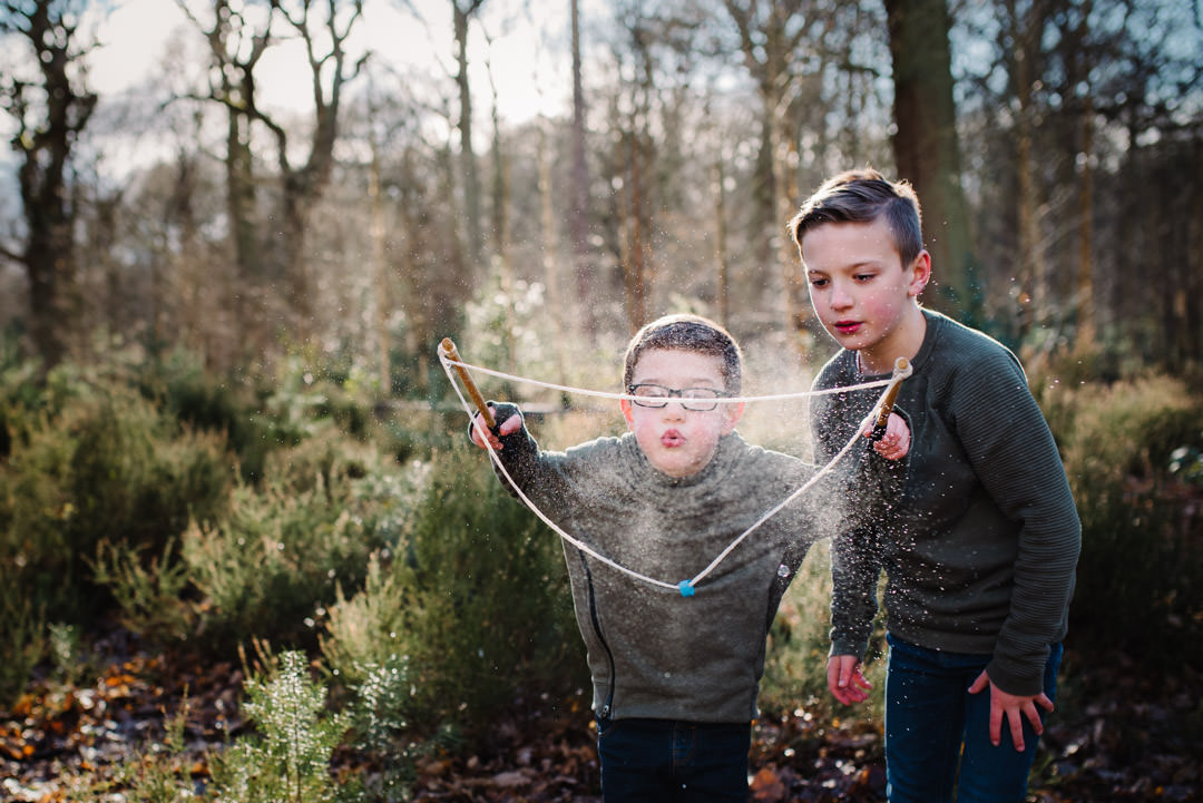 family photography of two boys playing with bubbles