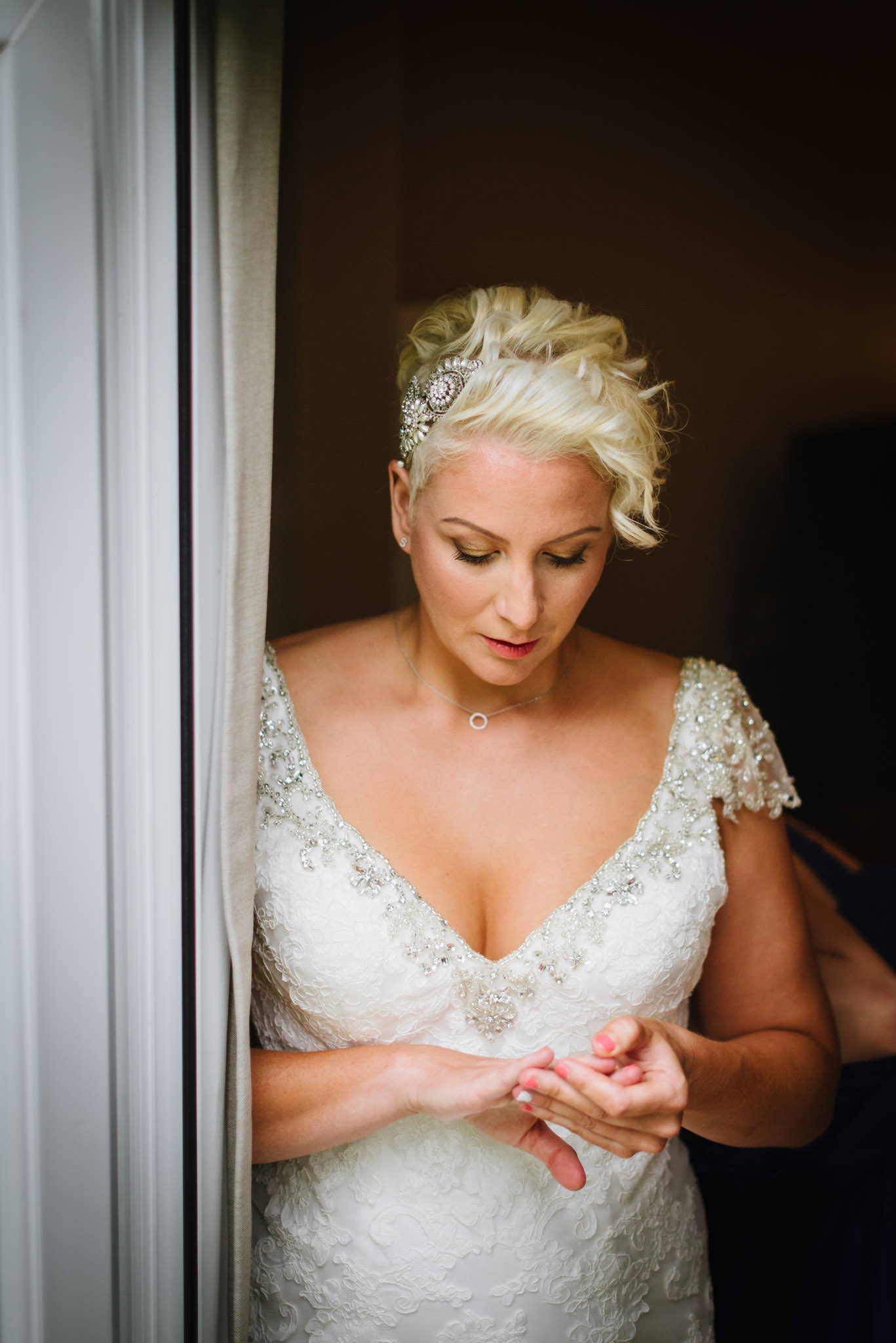 bride checking her ring at aldwickbury park wedding