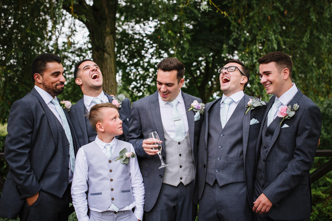 Groom and the groomsmen laugh at Essendon Country Club wedding