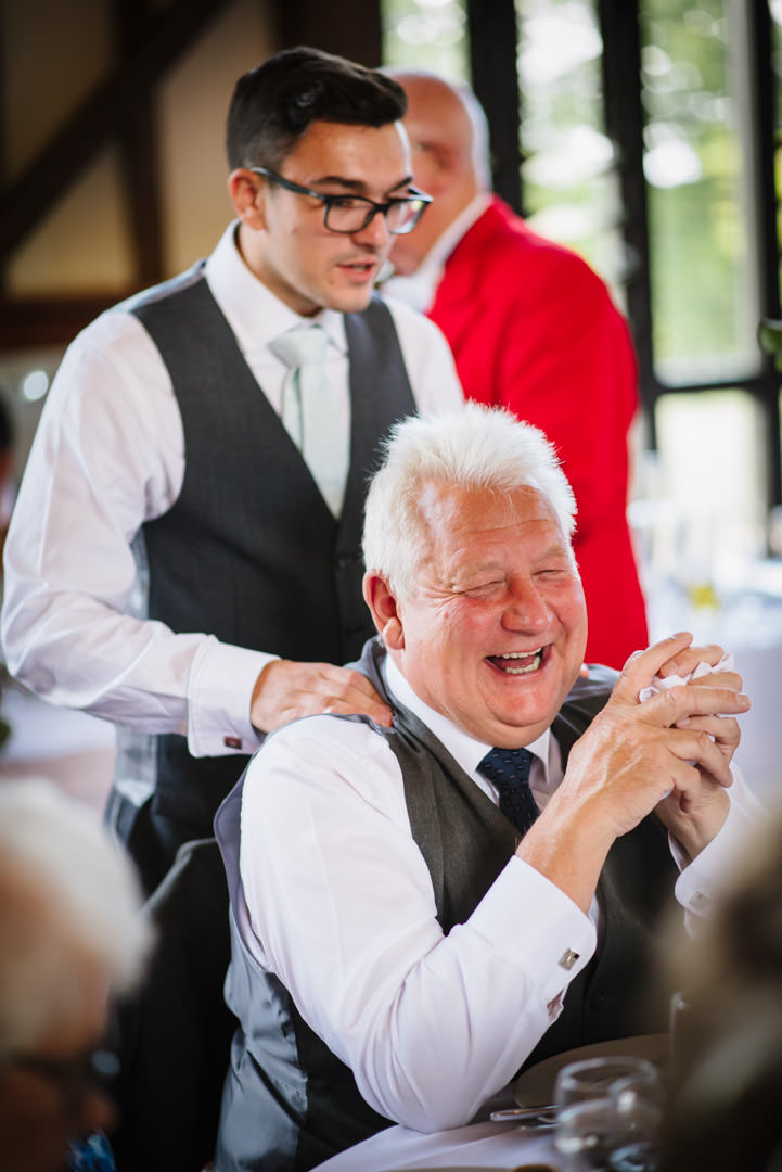 Groomsmen laugh at speeches during Essendon wedding 