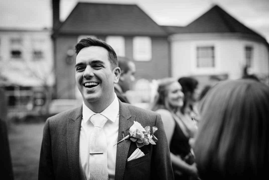 Groom laughs after his Hertfordshire wedding ceremony