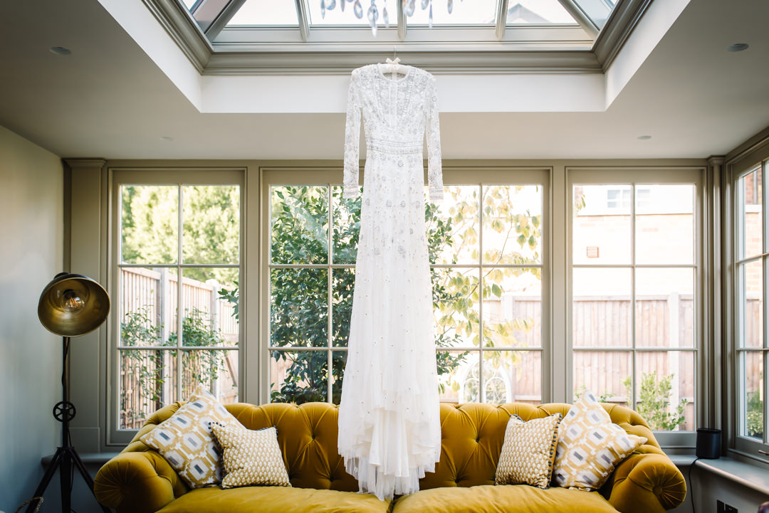 wedding dress by needle and thread hanging ready to be worn