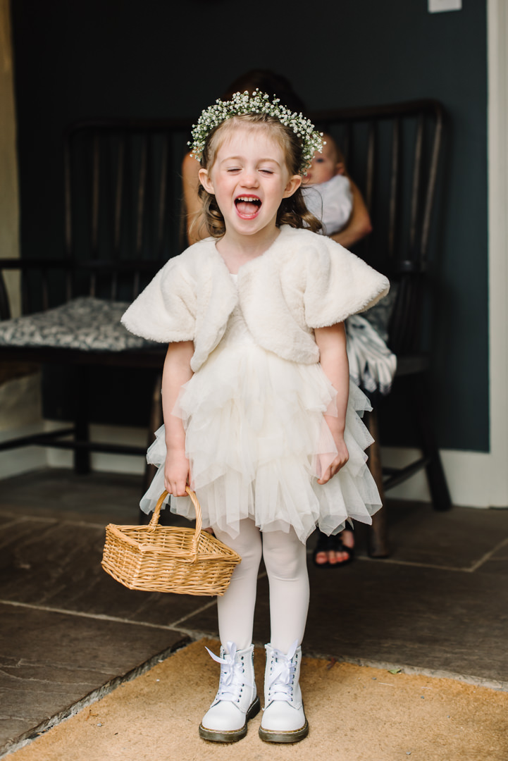 little bridesmaid laughs at her photo being taken