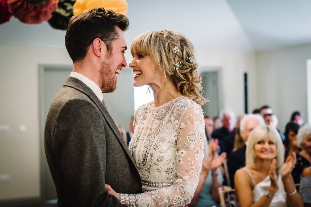 joyous exchange between bride and groom as they are pronounced man and wife