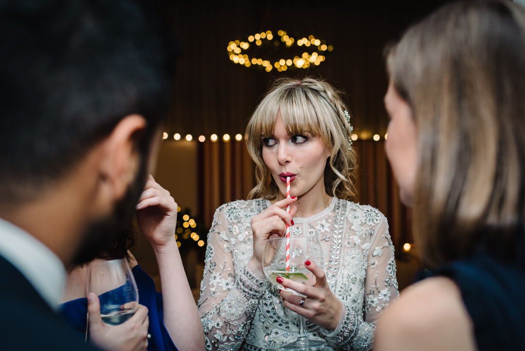 bride sipping gin and tonic at her wedding