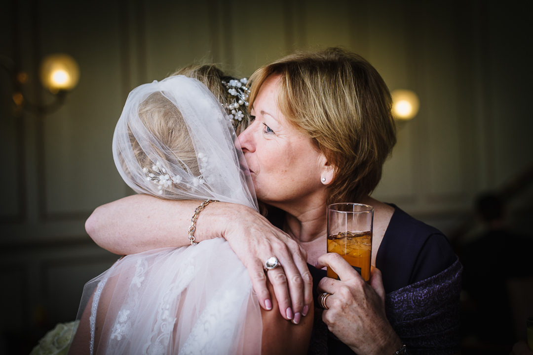 tender moment between bride and one of her guests at Gosfield Hall wedding. Essex.