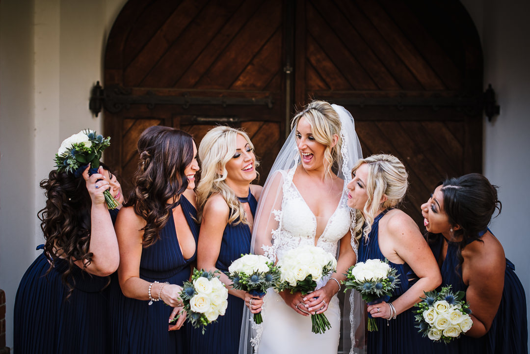 brides and bridesmaids laughing together after a gosfield hall wedding