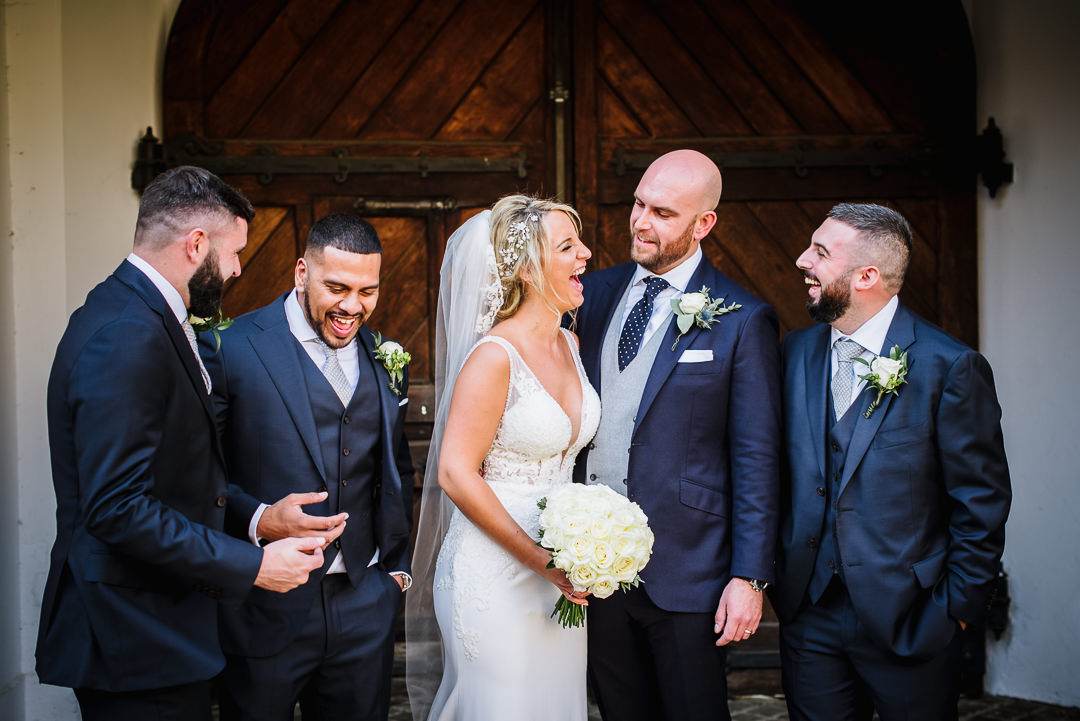 gosfield hall sets the scene for a groom and groomsmen photo