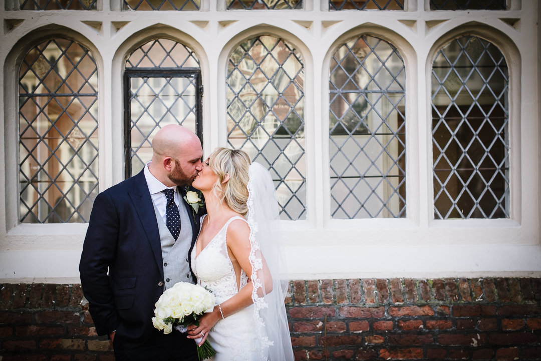 bride and groom kiss captured by Gosfield Hall wedding photographer