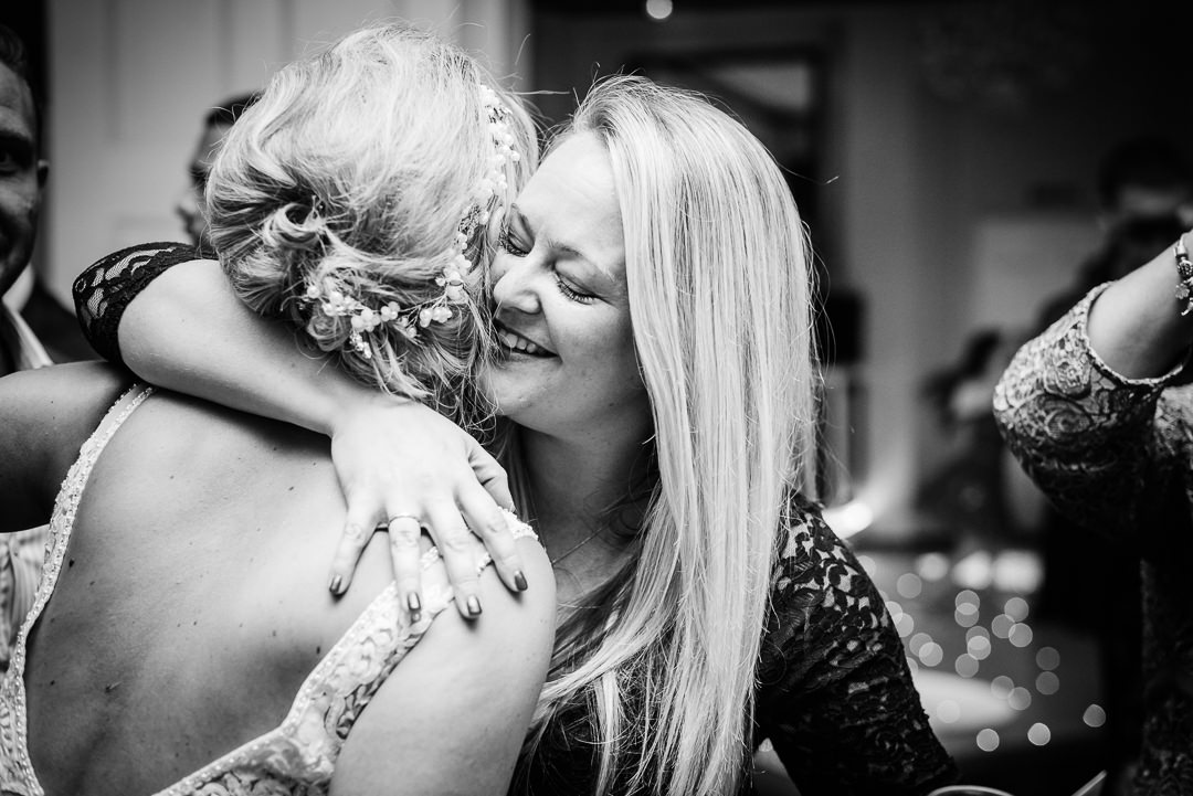 Hugging wedding guests captured by Hertfordshire wedding photographer