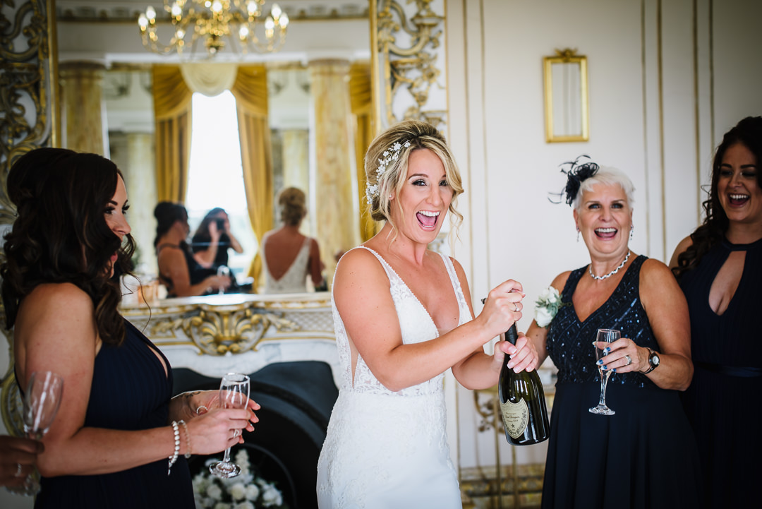 Gosfiled hall wedding photographer documents Bride and her bridesmaids enjoying a glass of champagne before the wedding ceremony.
