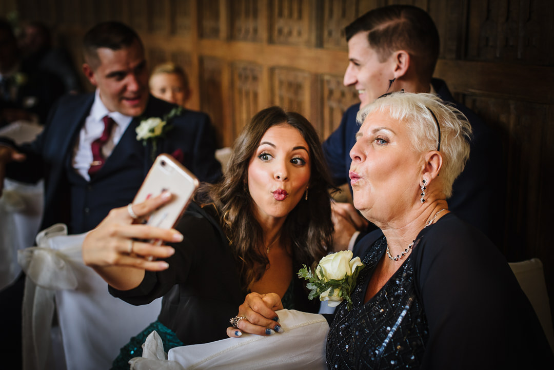 guests pose for selfies before the ceremony at Gosfield Hall wedding
