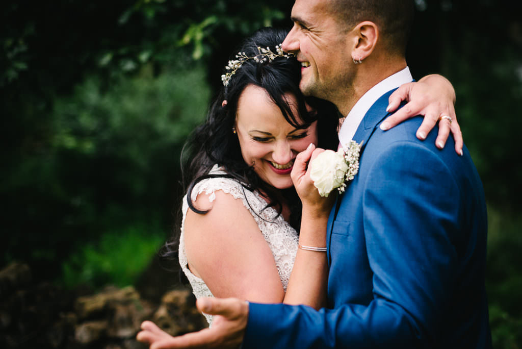 sweetly giggling newly weds pose for their hertfordshire wedding photographer