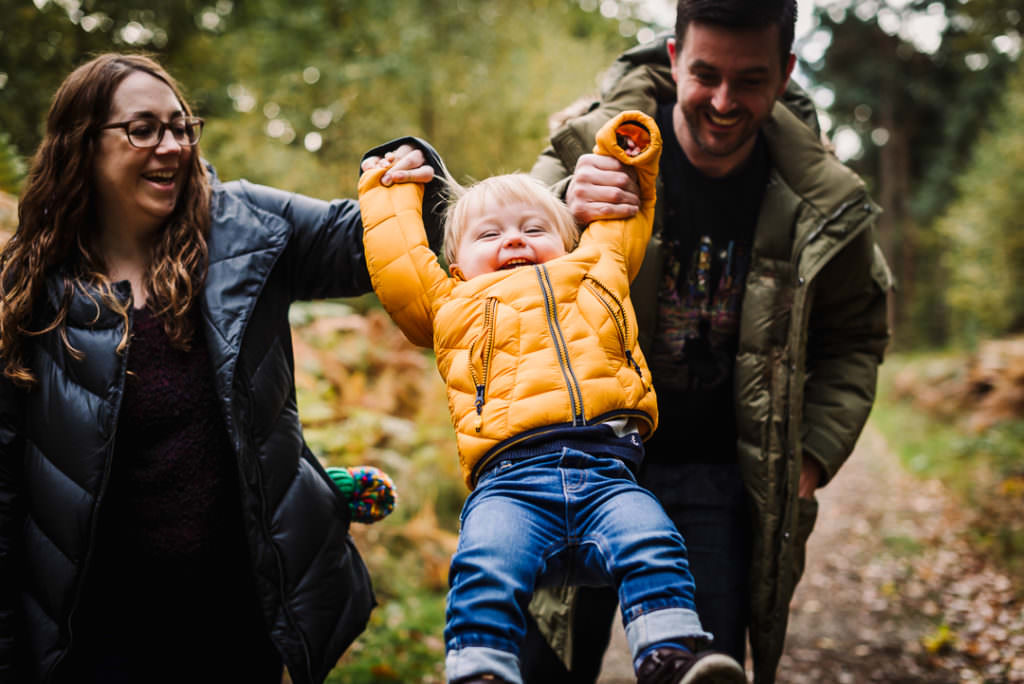 families playing in the woods for their hertfordshire family photographer