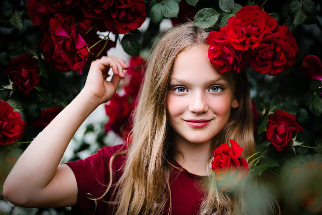 a child stands amongst a bright display of roses in welwyn garden city