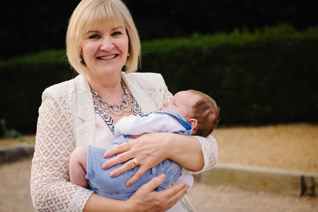 New grandmother holds her grand son for relaxed family photography St Albans.