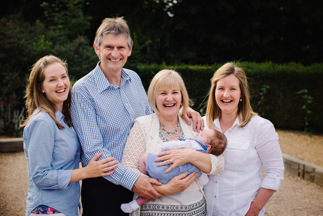 New addition to the family is held by his grandmother and surrounded by his doting mum and auntie to in St Albans