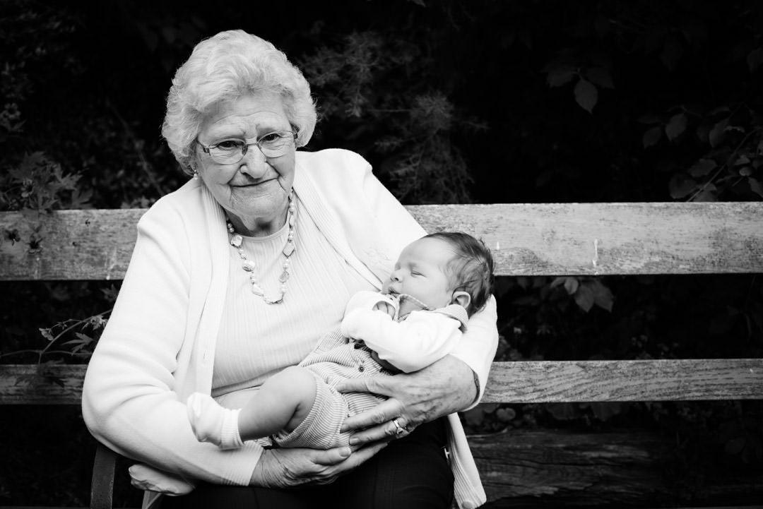 Great grandmother holds her first great grand child in St Albans during a relaxed family photo session.