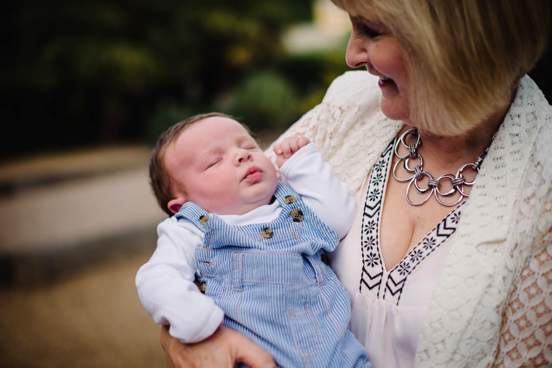 Doting new grand mother looks proudly at her grandson during their Relaxed family photography St Albans.