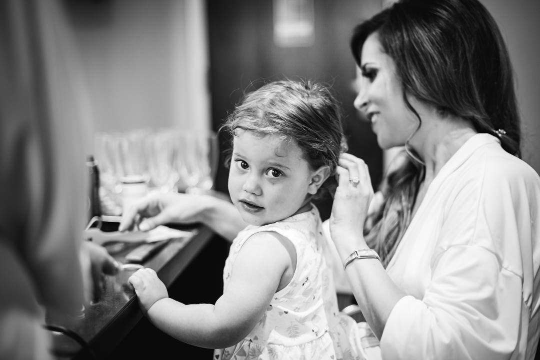 tender moment between bride and her little daughter during bridal prep at their bull hotel gerrards cross wedding