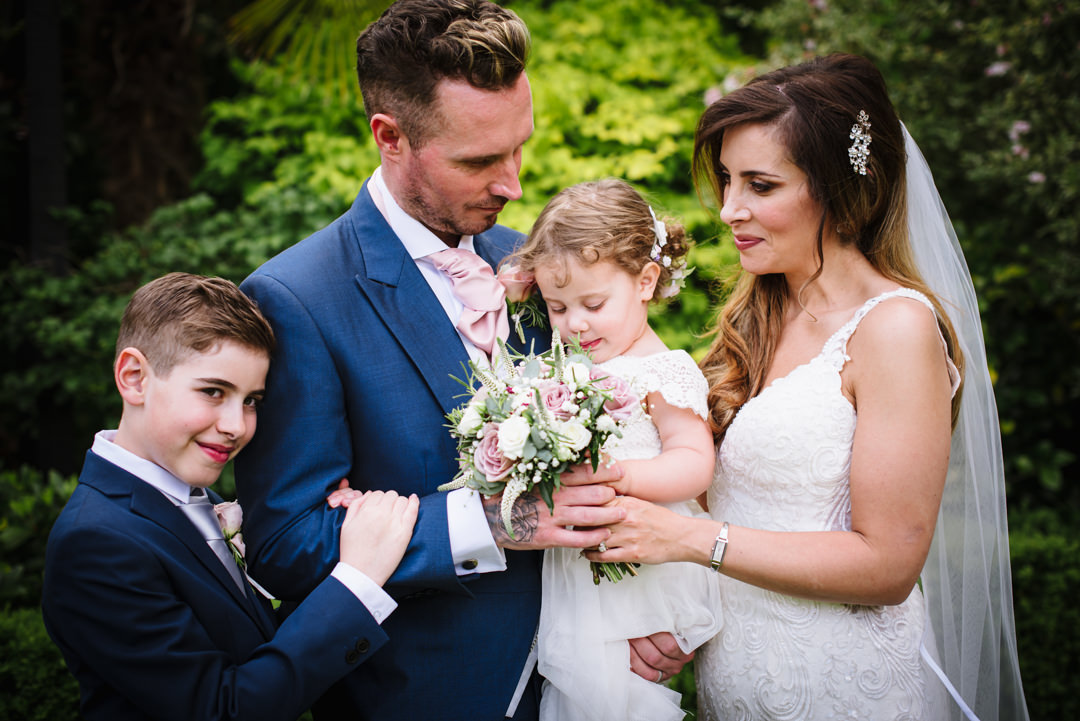 family portrait of bride and groom and their two children during their gerrards cross wedding day