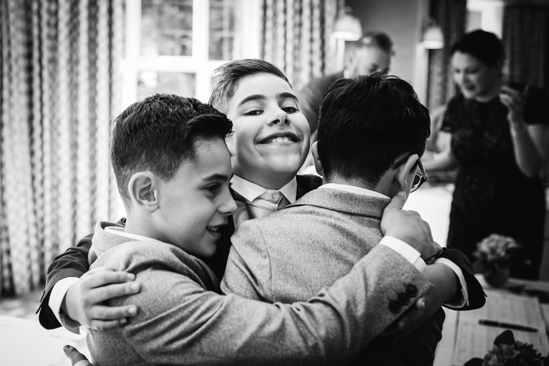 happy kids having a hug at the bull hotel gerrards cross wedding