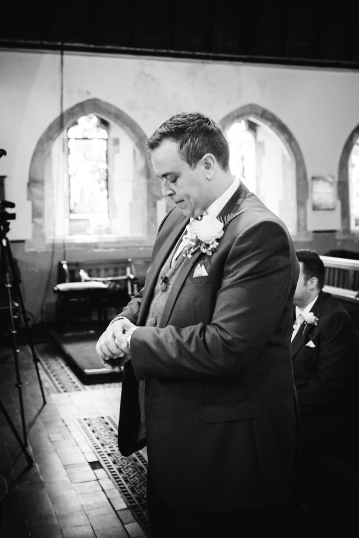 groom looking at his watch before the wedding ceremony