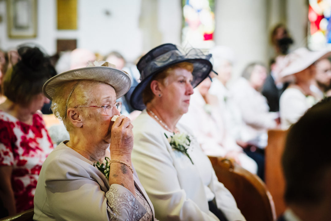 grandmother of the groom sheds an emotional tear at wedding ceremony