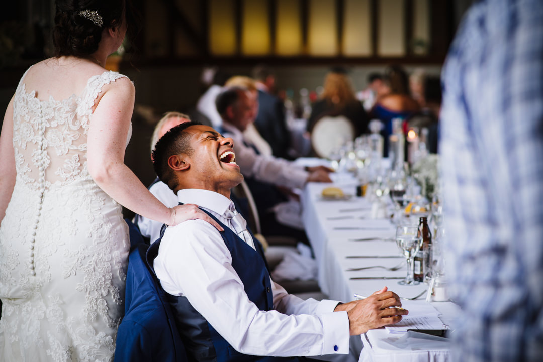 best man really laughing at a joke made by the bride at essendon