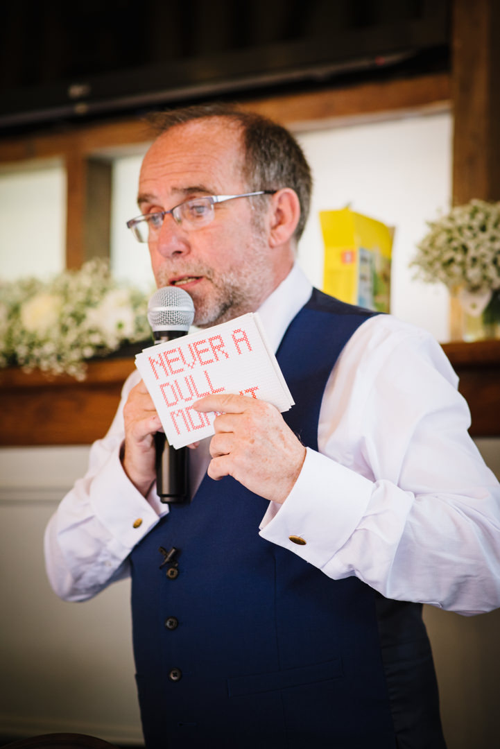 father of the bride holding up his speech cards saying never a dull moment