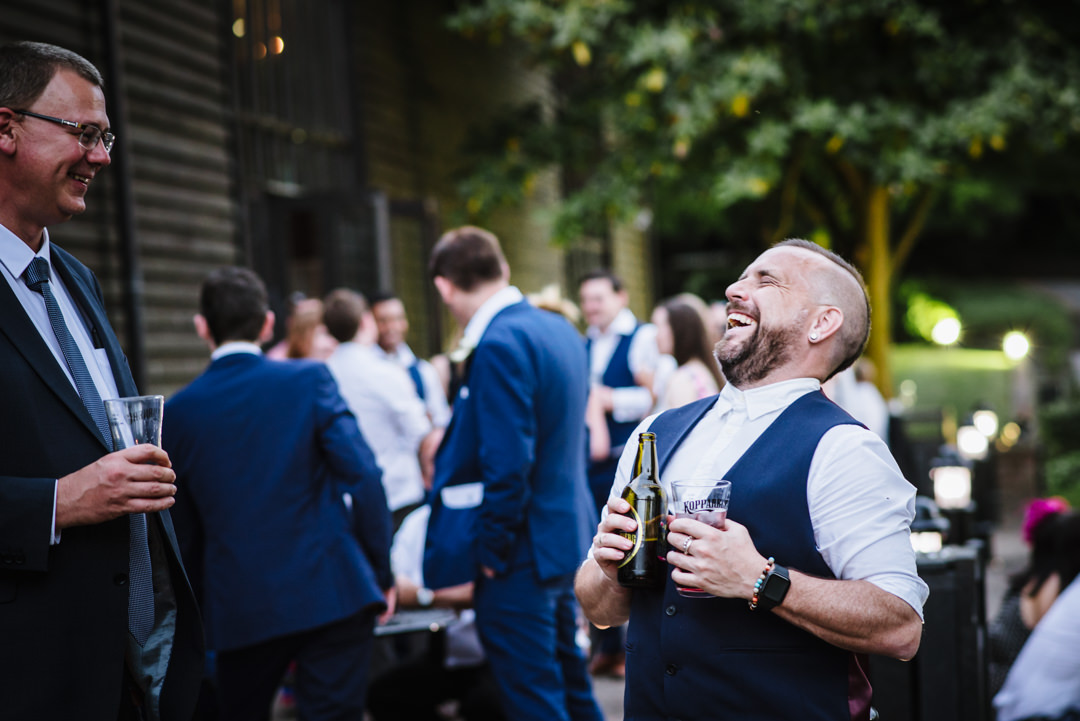 male essendon wedding guest enjoying his beer and laughing